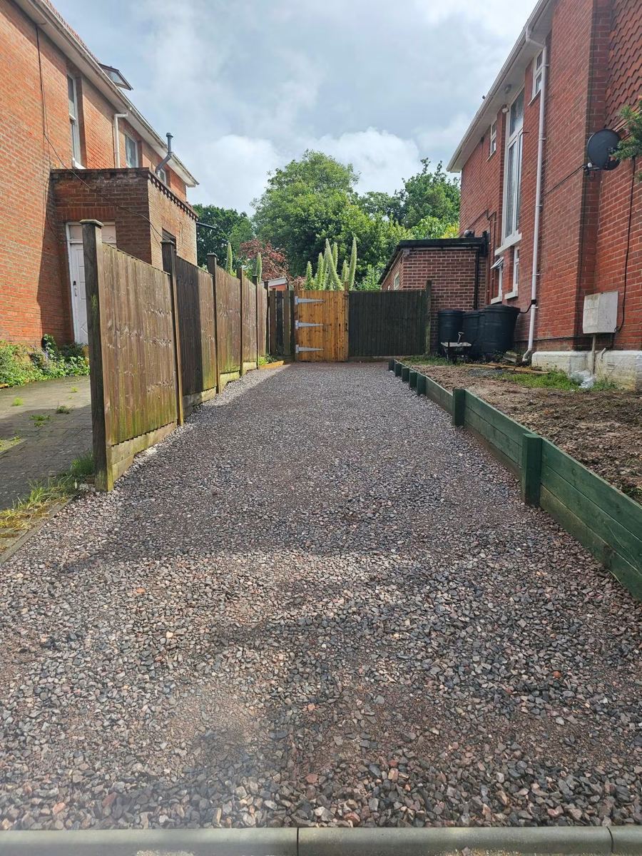 Gravel drive between two houses with new timber gate and edging