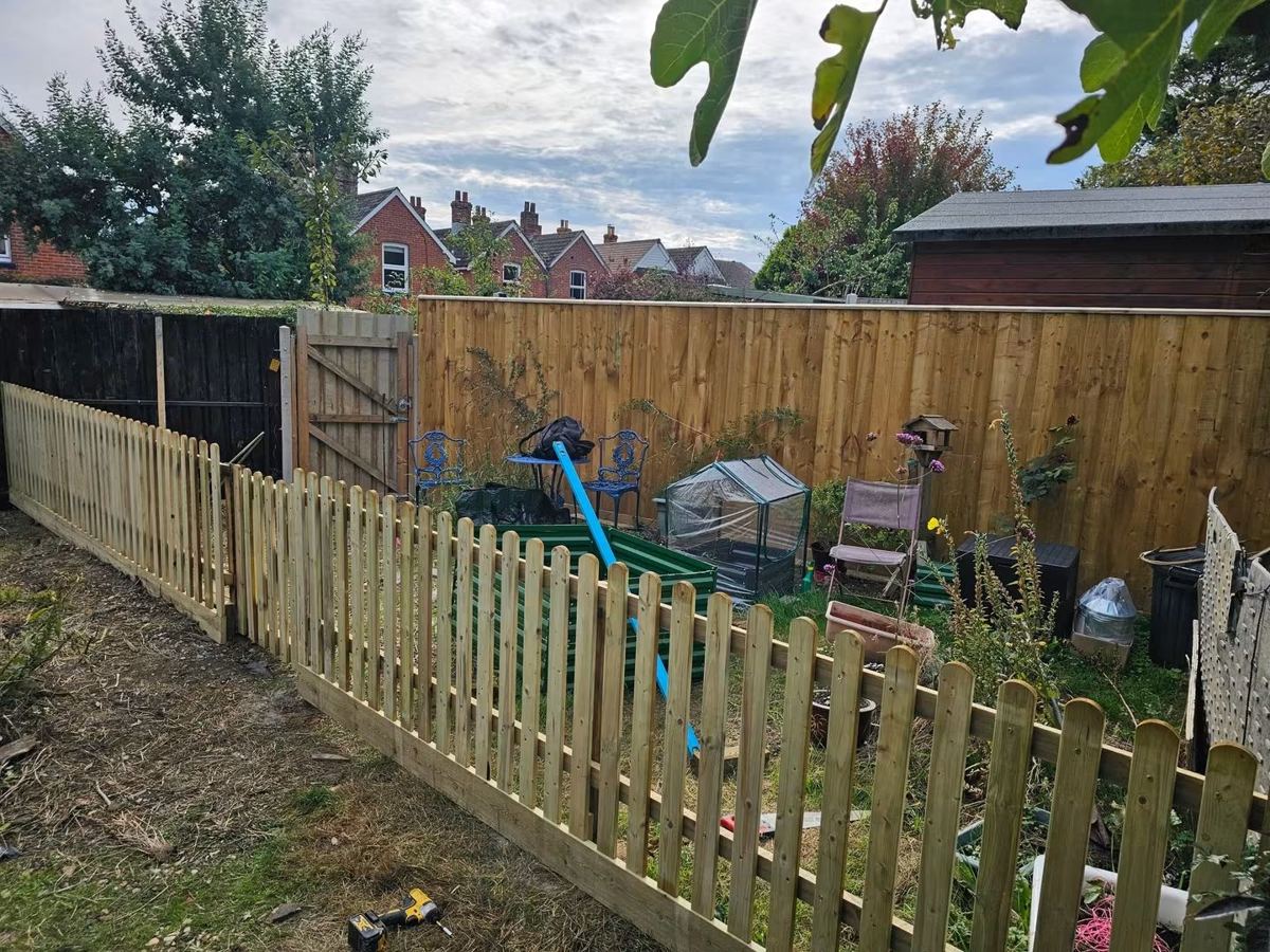 New timber picket fence and closeboard fence around a garden